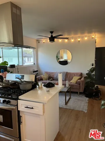 a kitchen with a sink a stove and cabinets