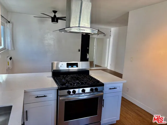 a stove top oven sitting inside of a kitchen