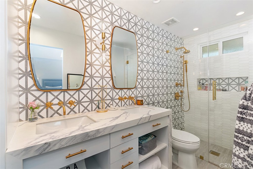 609 Seaward Road Corona del Mar, CA 92625 - Photo 16 of 22 a bathroom with a sink and mirror with toilet
