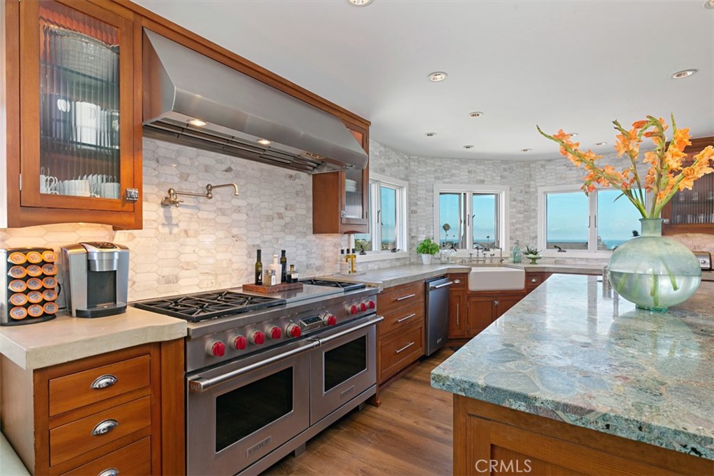 609 Seaward Road Corona del Mar, CA 92625 - Photo 2 of 22 a kitchen with stainless steel appliances granite countertop a stove a sink and a wooden cabinets