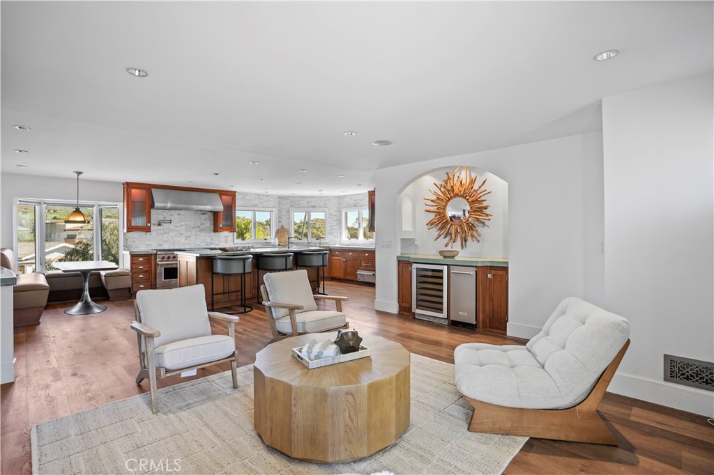 609 Seaward Road Corona del Mar, CA 92625 - Photo 4 of 22 a living room with furniture a fireplace and a large window