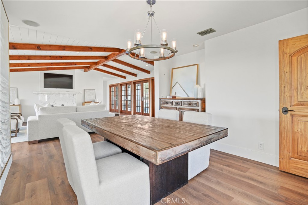 609 Seaward Road Corona del Mar, CA 92625 - Photo 6 of 22 a open kitchen with a table and chairs