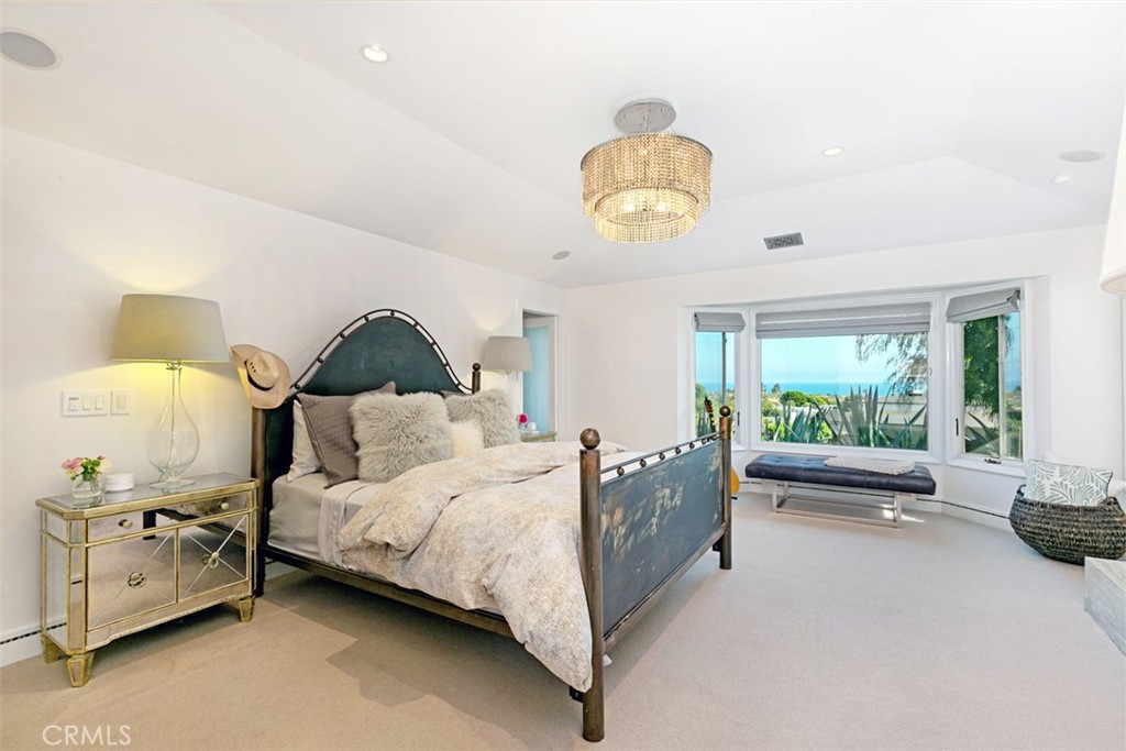 609 Seaward Road Corona del Mar, CA 92625 - Photo 7 of 22 a spacious bedroom with a bed and a large window