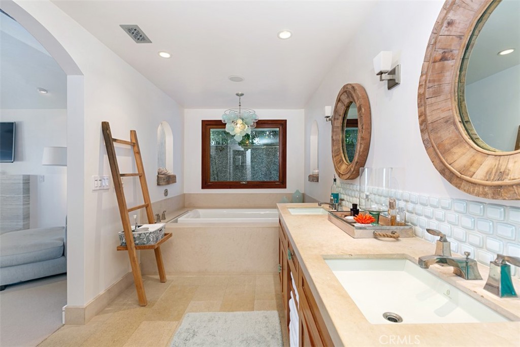 609 Seaward Road Corona del Mar, CA 92625 - Photo 10 of 22 a bathroom with a sink a mirror and a bathtub