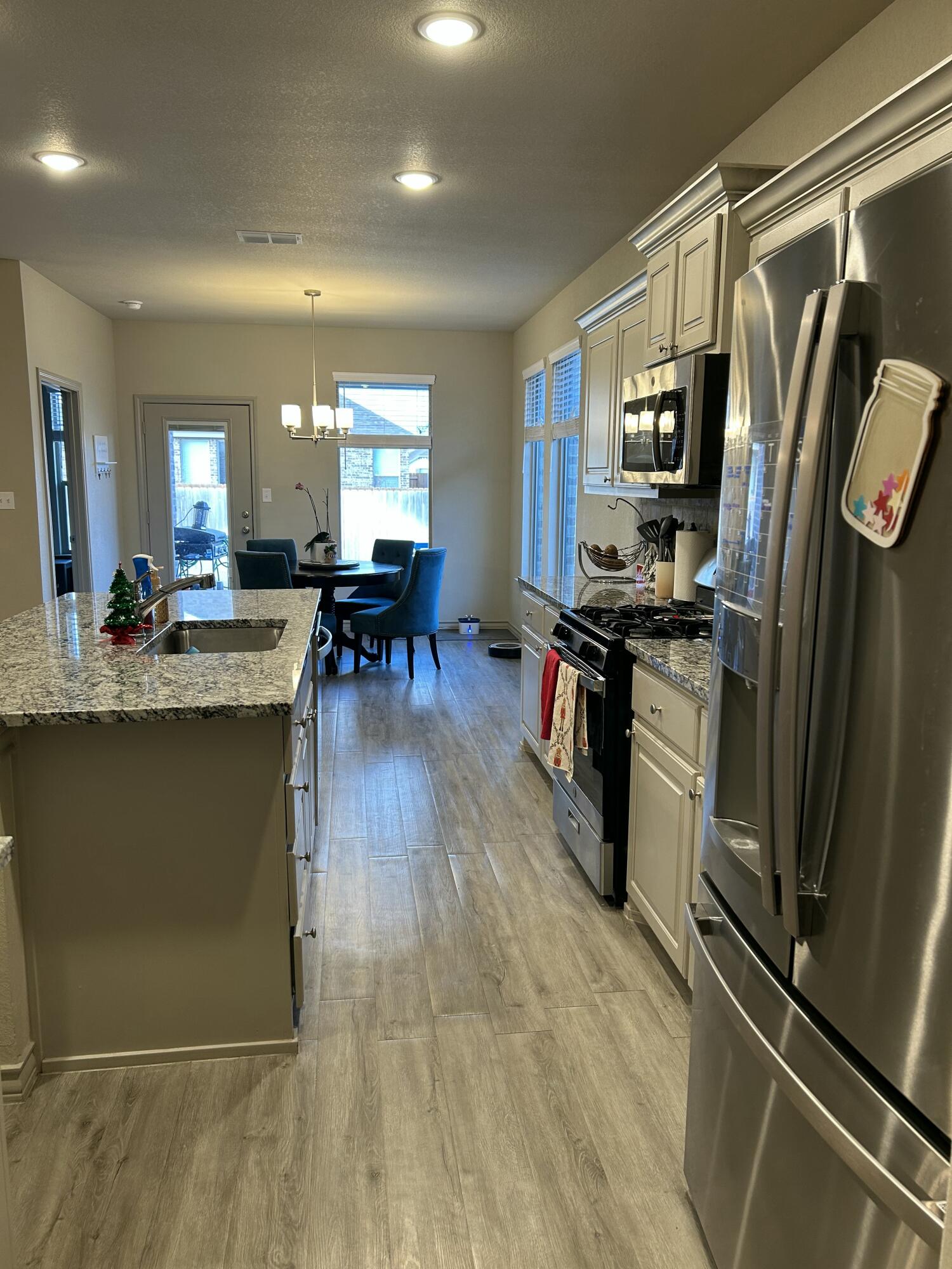7020 22nd Street Lubbock, TX 79407 - Photo 11 of 28 a kitchen with stainless steel appliances granite countertop a refrigerator stove and sink