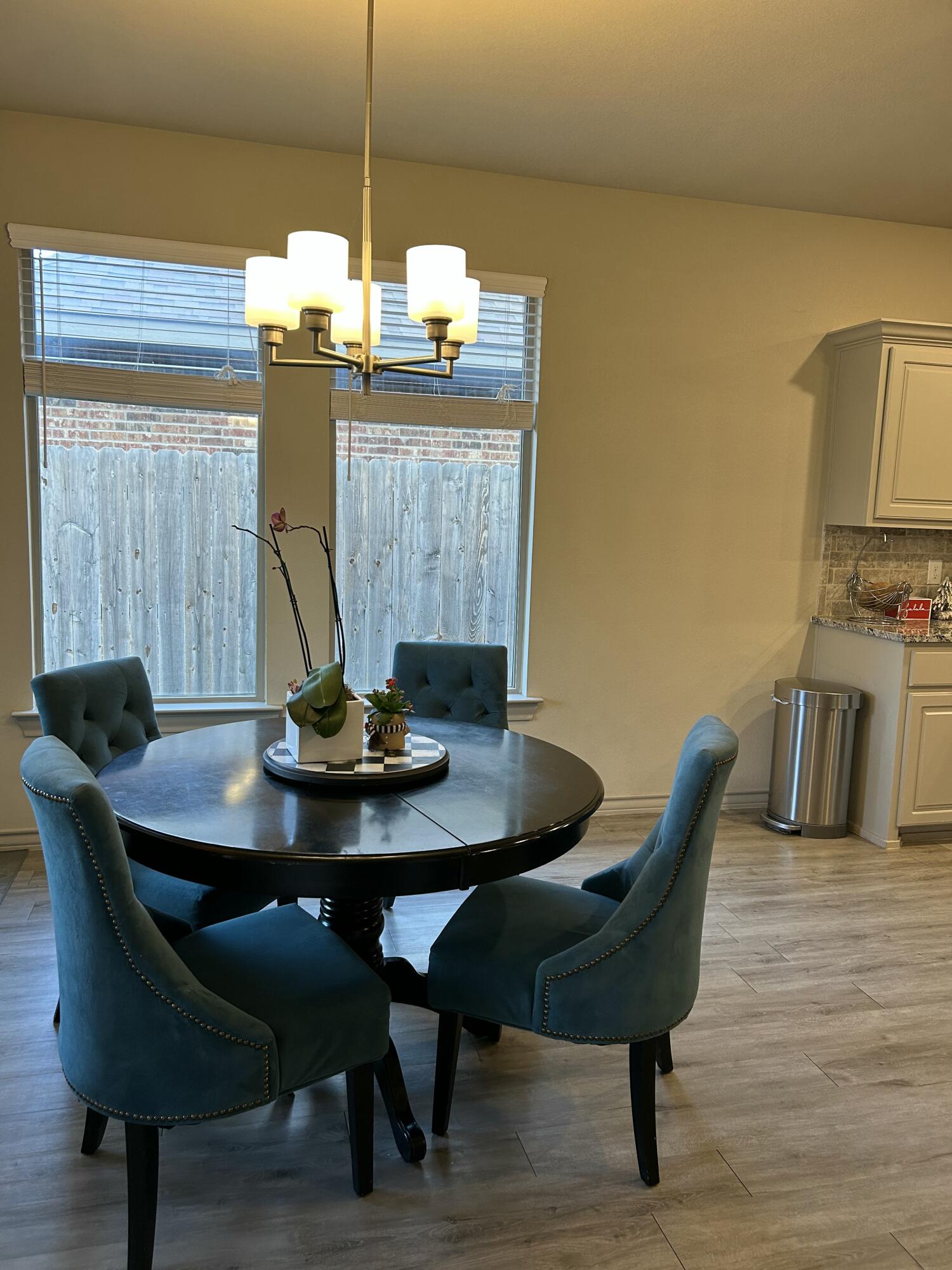 7020 22nd Street Lubbock, TX 79407 - Photo 13 of 28 a view of a dining room with furniture and wooden floor