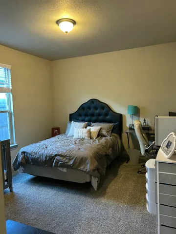 a bedroom with a bed and a car