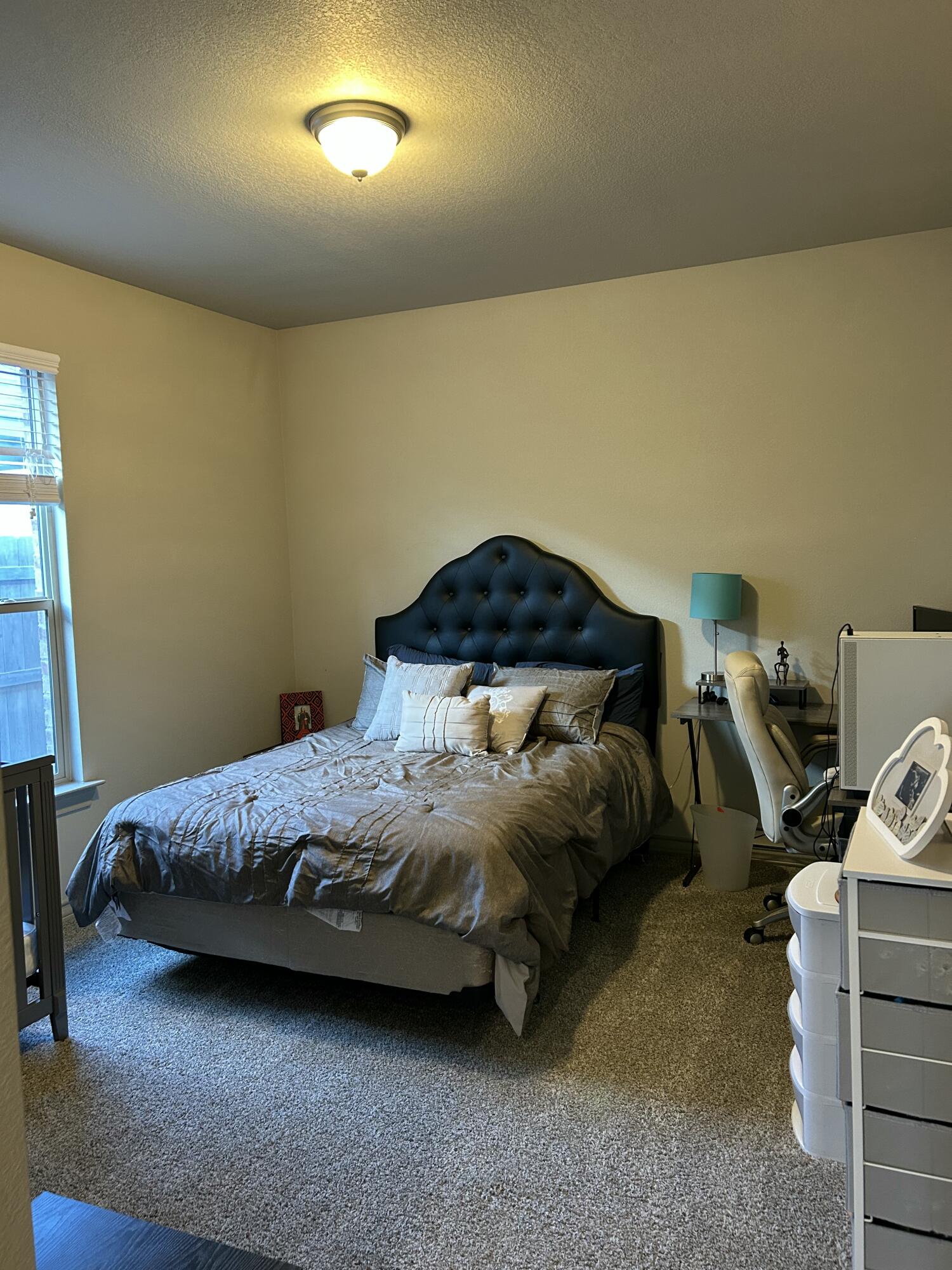 7020 22nd Street Lubbock, TX 79407 - Photo 16 of 28 a bedroom with a bed and a car