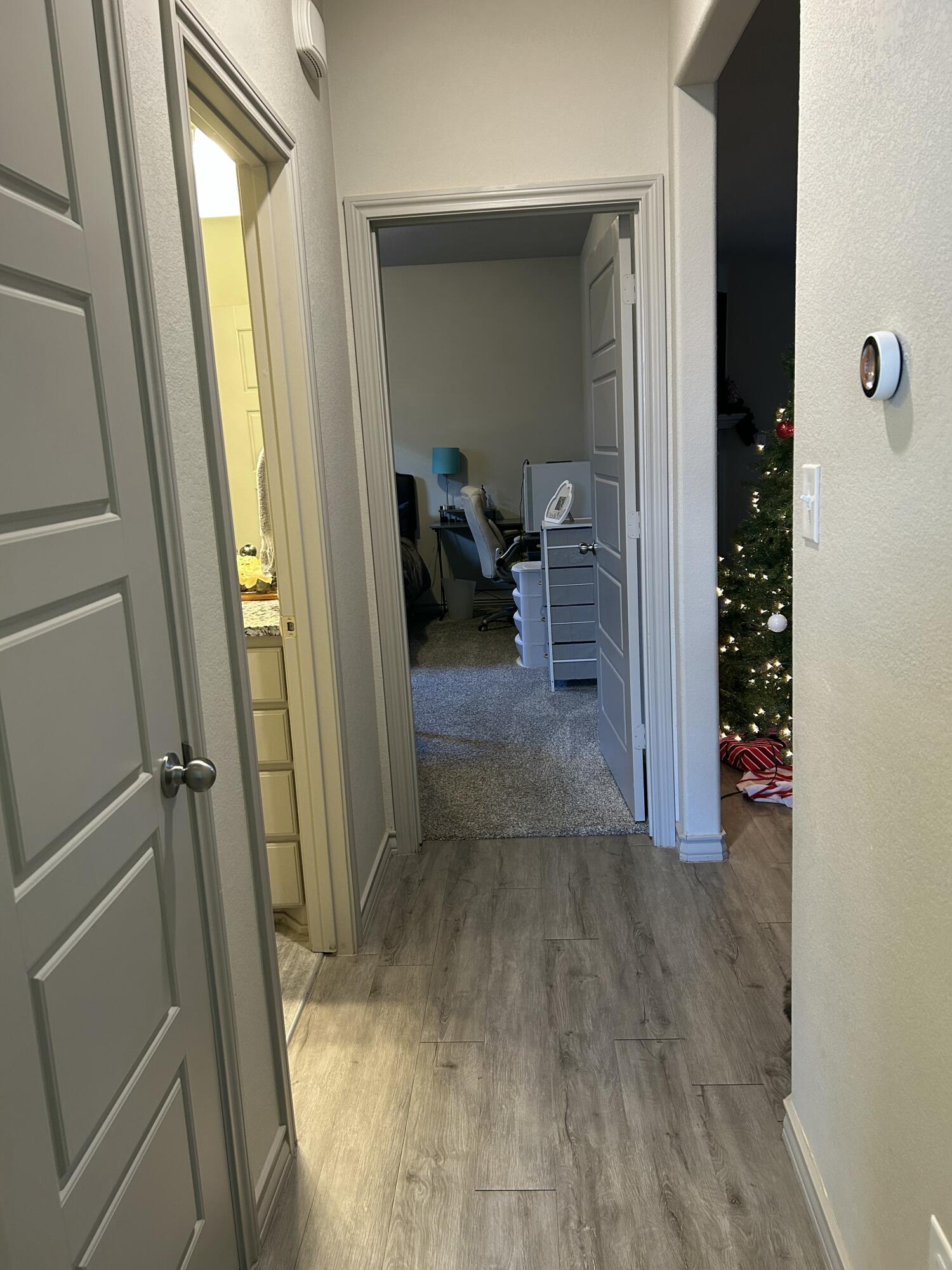 7020 22nd Street Lubbock, TX 79407 - Photo 18 of 28 a view of a hallway view with wooden floor and living room
