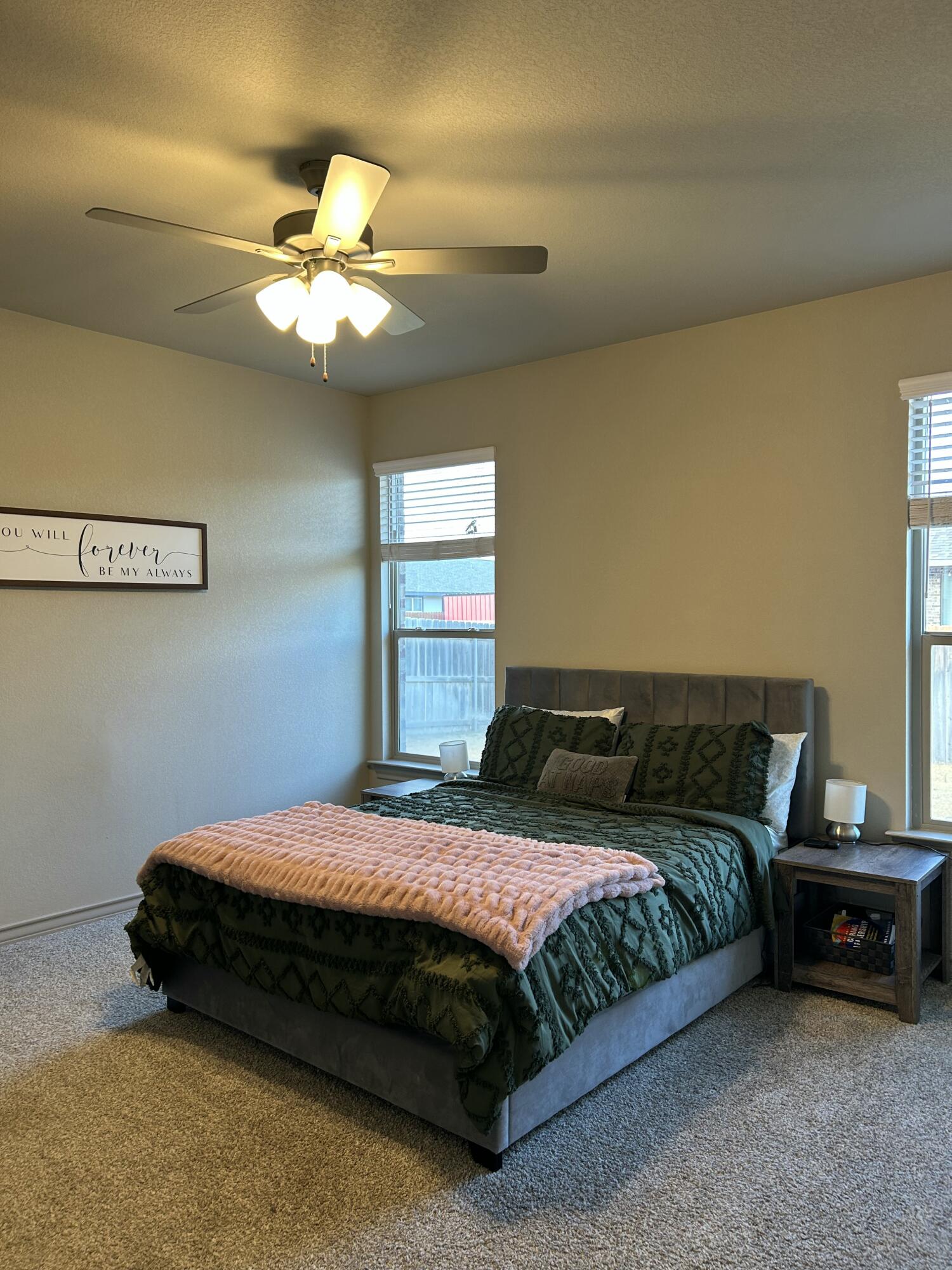 7020 22nd Street Lubbock, TX 79407 - Photo 22 of 28 a bedroom with a bed and a ceiling fan