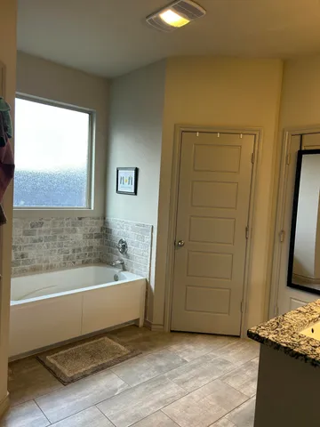 a bathroom with a bathtub and a shower