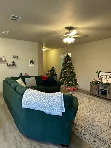 a living room with furniture and a chandelier