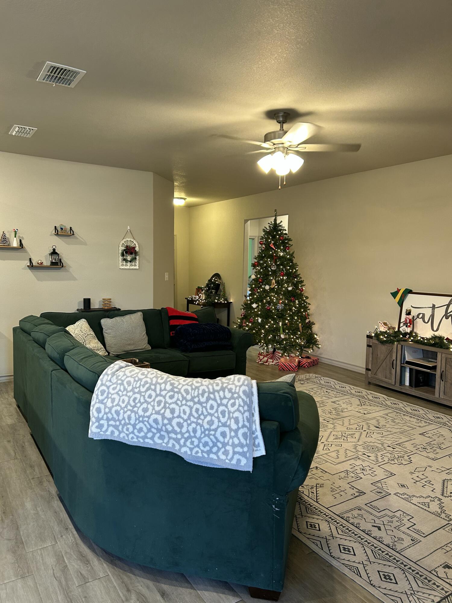 7020 22nd Street Lubbock, TX 79407 - Photo 7 of 28 a living room with furniture and a chandelier