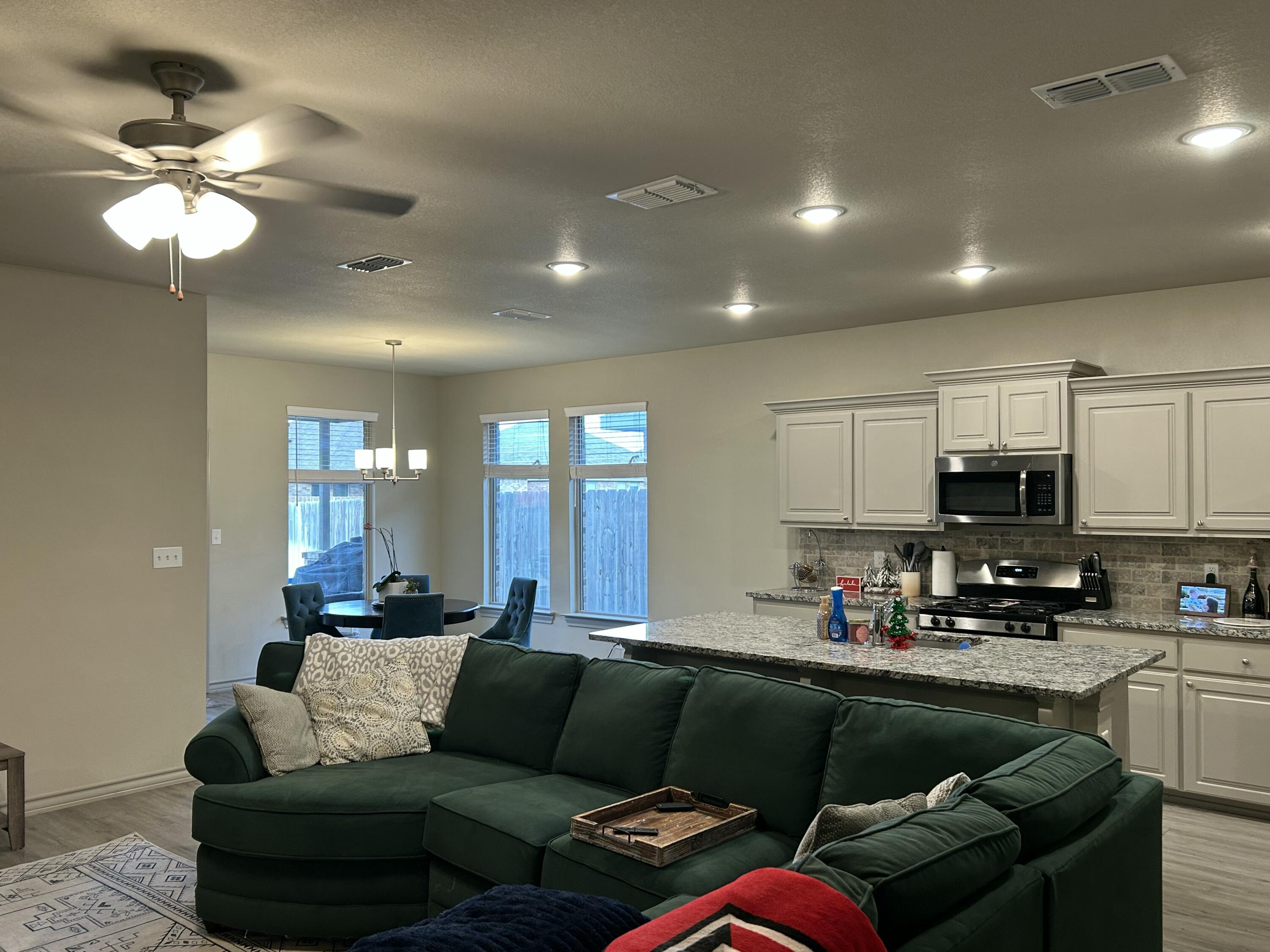 7020 22nd Street Lubbock, TX 79407 - Photo 8 of 28 a living room with furniture and kitchen view