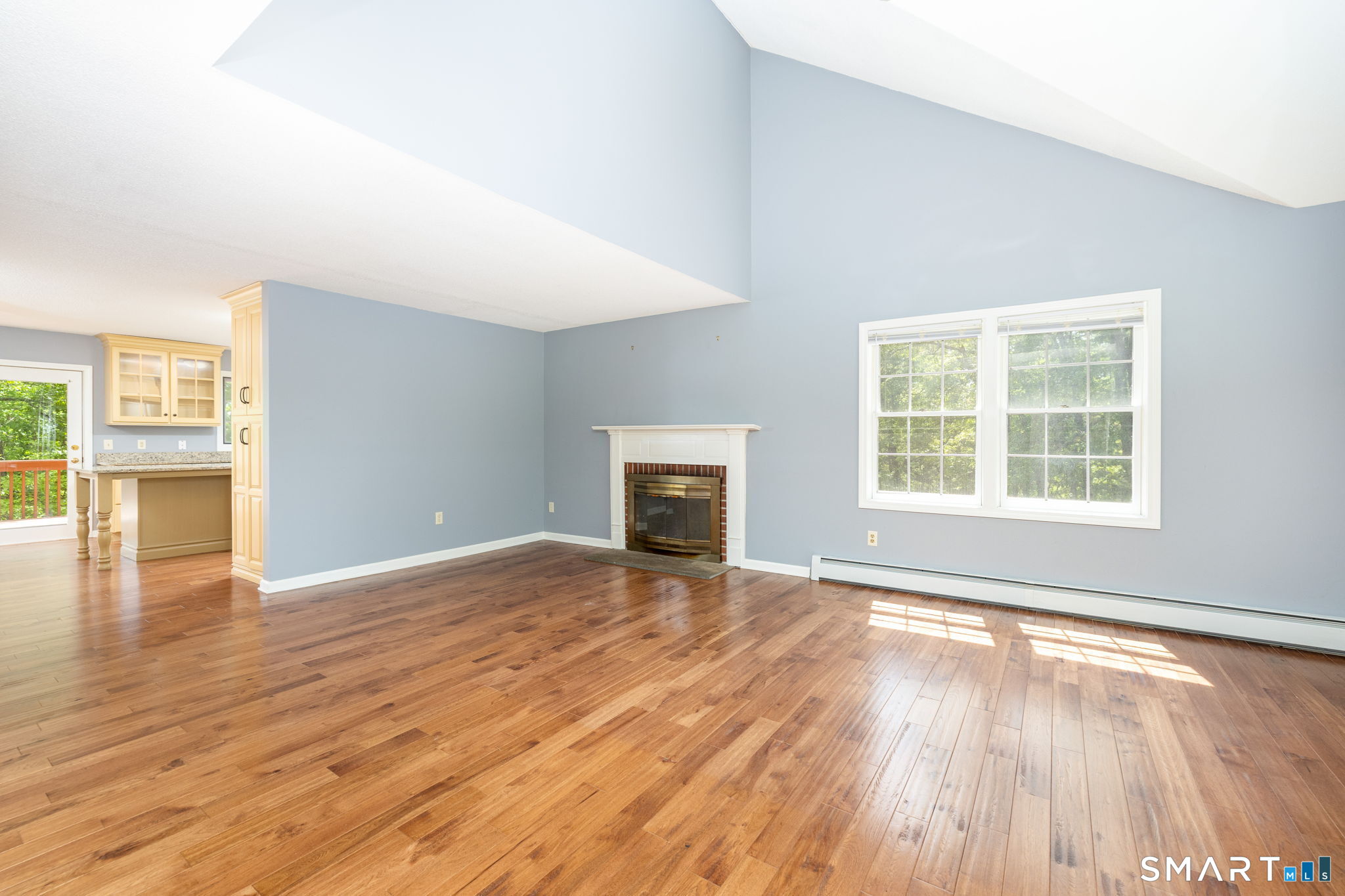 175 Vernon Street Manchester, CT 06042 - Photo 6 of 38 an empty room with wooden floor and windows