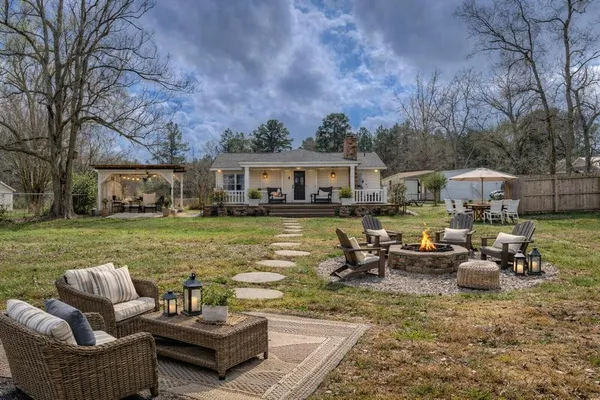 a view of a house with swimming pool and porch with furniture