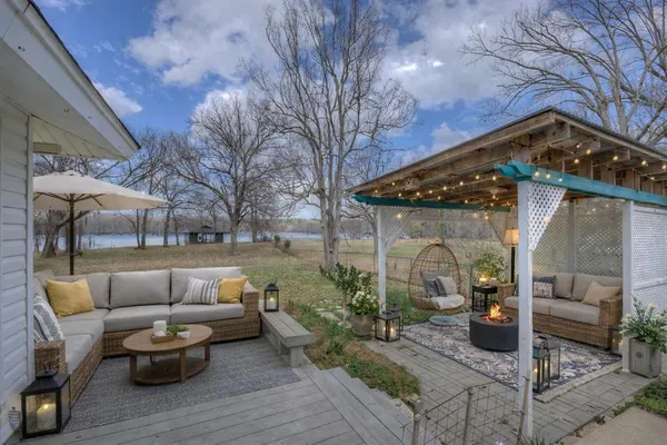 a view of a house and a patio with a yard