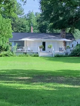 a house view with a sitting space and garden