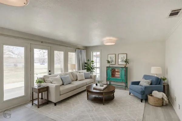 a living room with furniture and a large window