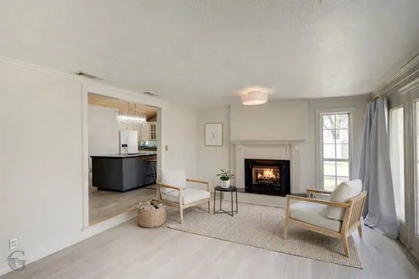 a living room with furniture a fireplace and window