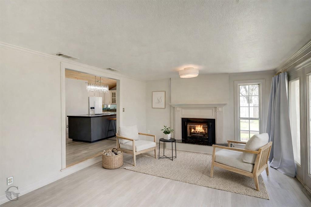 306 Pine Street Heflin, LA 71039 - Photo 7 of 14 a living room with furniture a fireplace and window