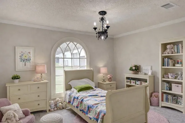 a bedroom with a bed cabinets and window