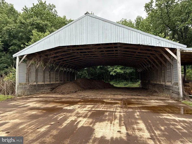 a view of a lake with lawn chairs and iron fence