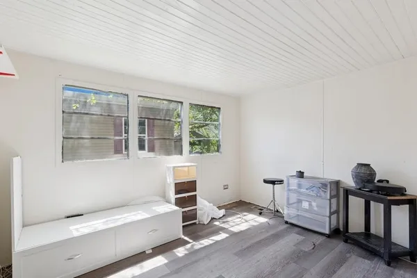 a bedroom with furniture and a window