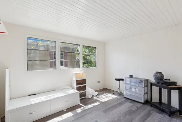 a bedroom with furniture and a window
