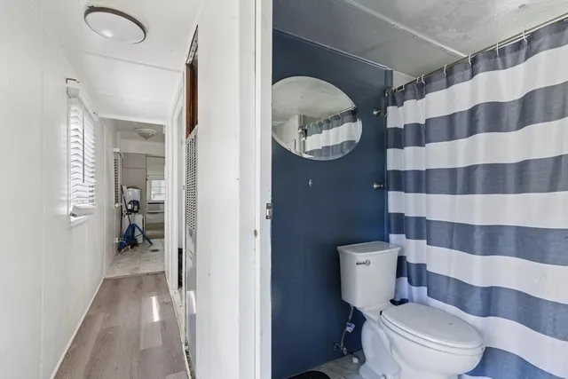 a bathroom with a toilet and a shower