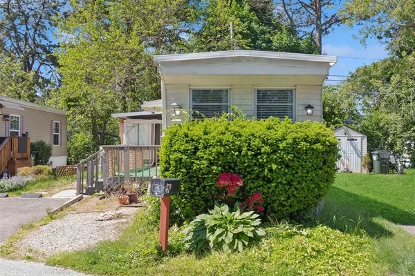 a view of a house with a yard and garden