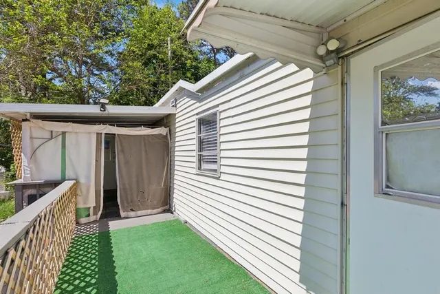 a view of backyard with cabin and wooden fence