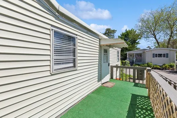 a view of house with backyard and deck
