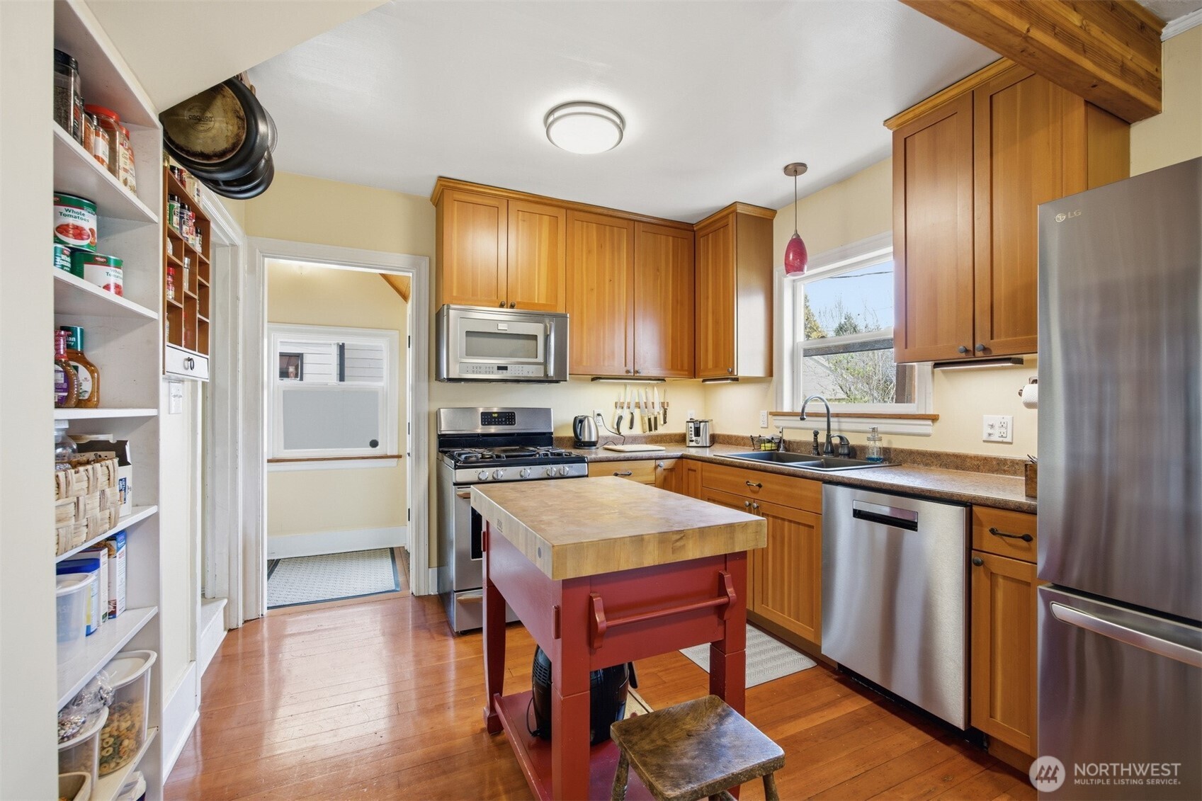 2712 Victor Street Bellingham, WA 98225 - Photo 10 of 40 a kitchen with stainless steel appliances granite countertop a refrigerator a sink dishwasher a stove and a dining table with wooden floor