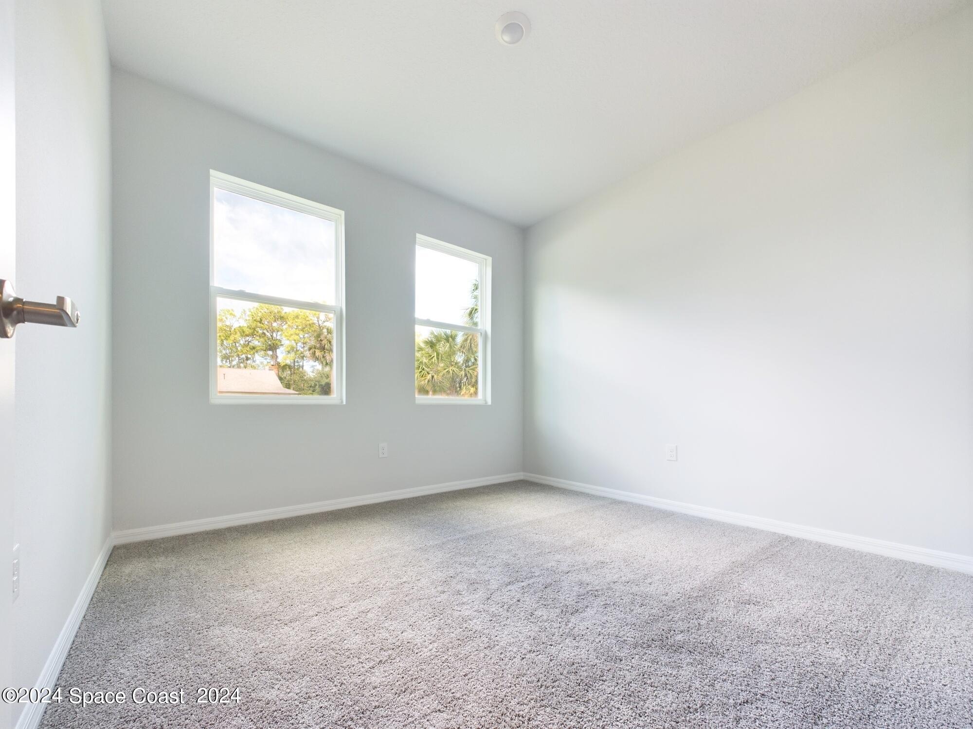 842 Angelico Road Northwest Palm Bay, FL 32907 - Photo 12 of 22 an empty room with windows