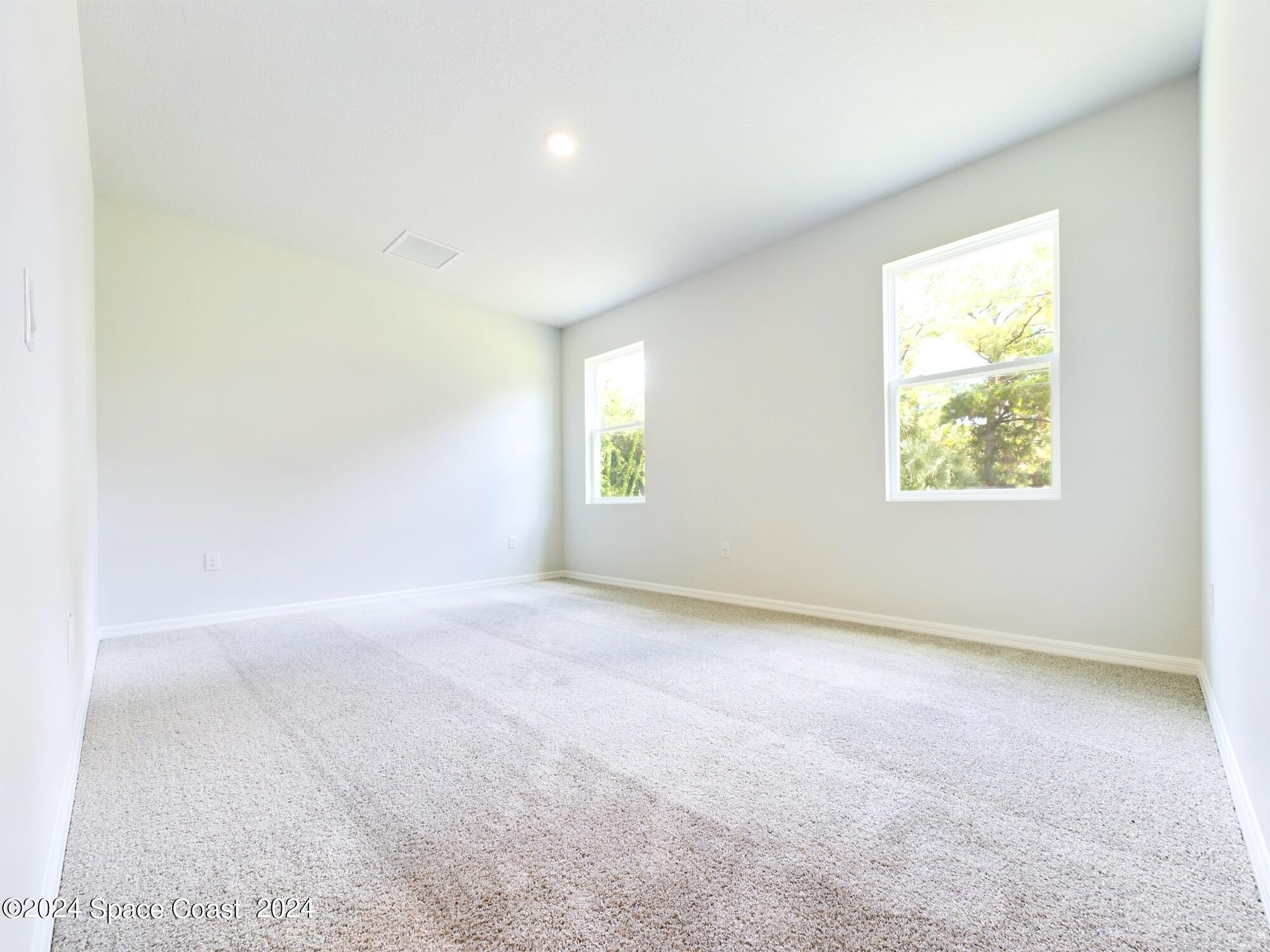 842 Angelico Road Northwest Palm Bay, FL 32907 - Photo 16 of 22 an empty room with windows