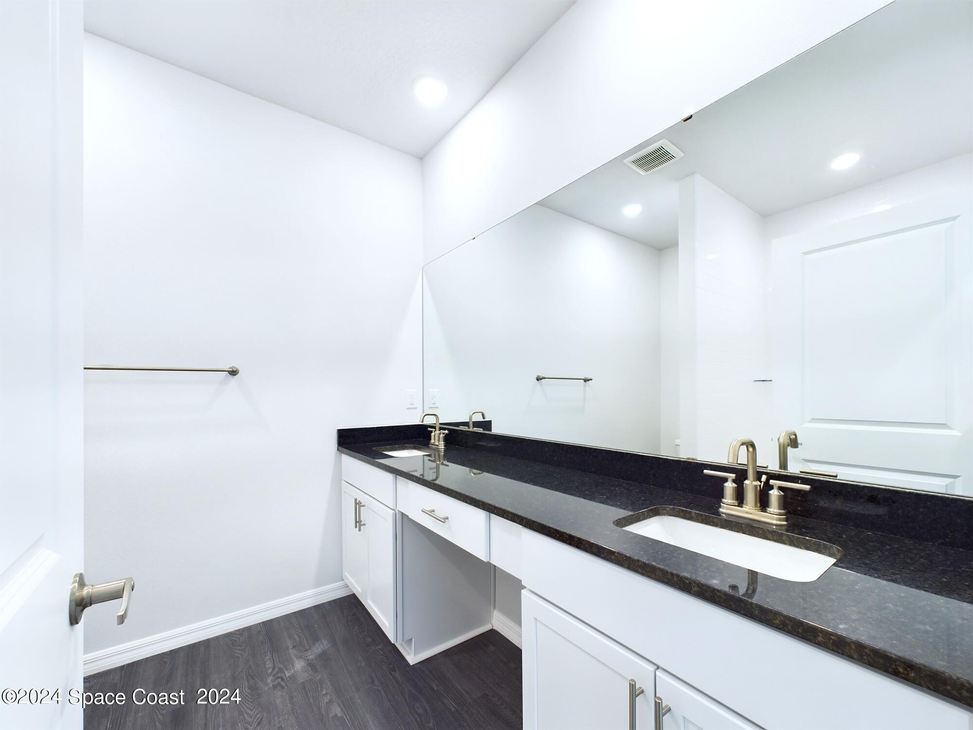 842 Angelico Road Northwest Palm Bay, FL 32907 - Photo 17 of 22 a bathroom with a sink and a mirror