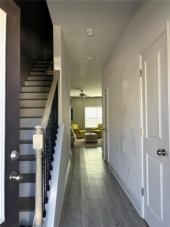 11208 Benton Loop Covington, GA 30014 - Photo 3 of 16 a view of a hallway view with wooden floor and staircase