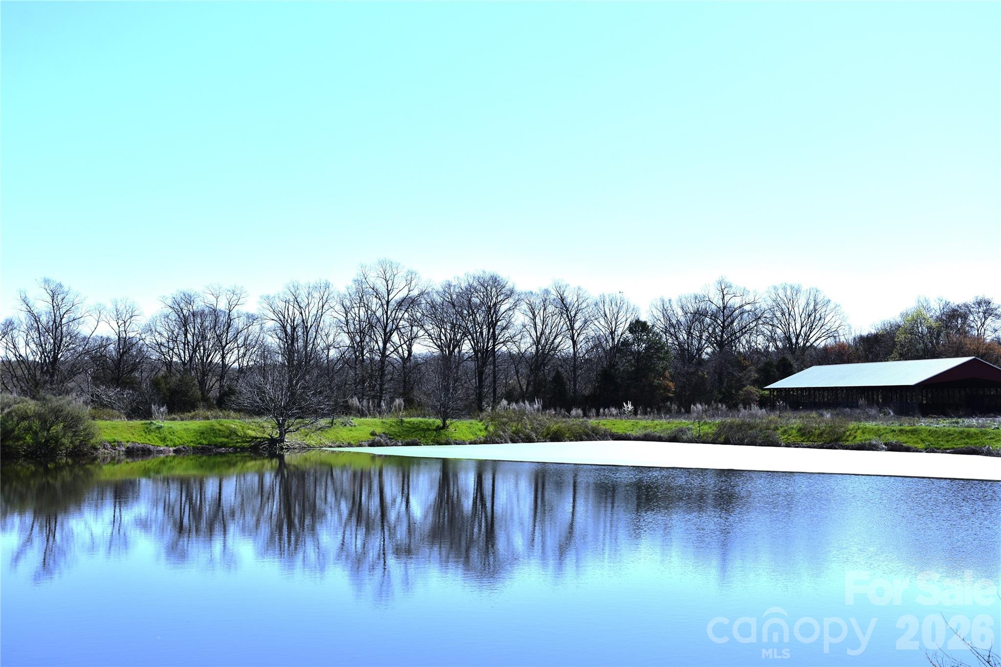 34230 George Road Albemarle, NC 28001 - Photo 24 of 26 a view of a lake with a yard and trees