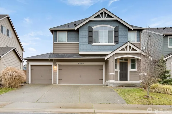 a view of a house with a yard and garage