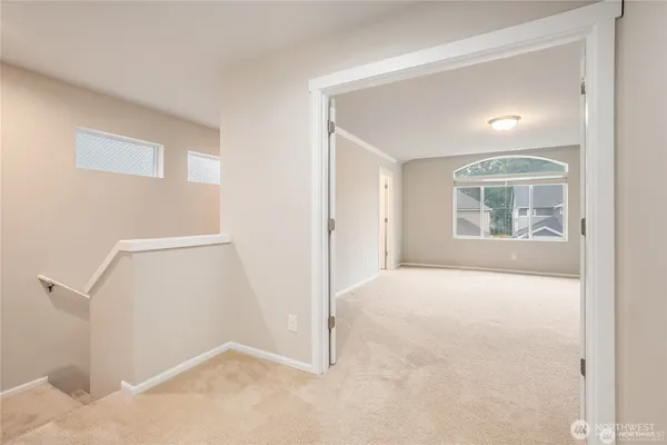 an empty room with windows and closet