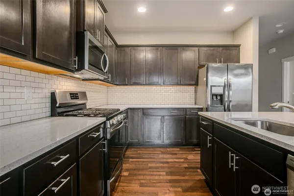 a kitchen with a sink and stainless steel appliances