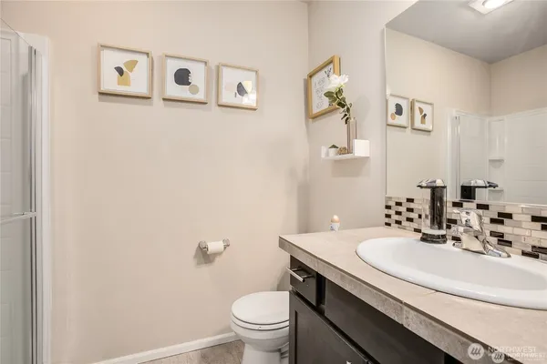 a bathroom with a sink mirror and toilet