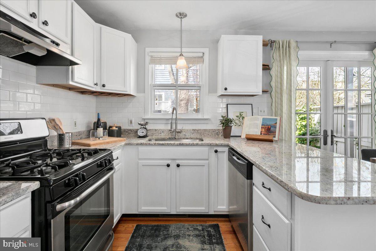 802 Pendleton Street Alexandria, VA 22314 - Photo 14 of 36 a kitchen with white cabinets and appliances