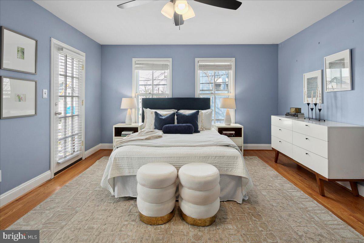 802 Pendleton Street Alexandria, VA 22314 - Photo 27 of 36 a bedroom with a bed and wooden floor