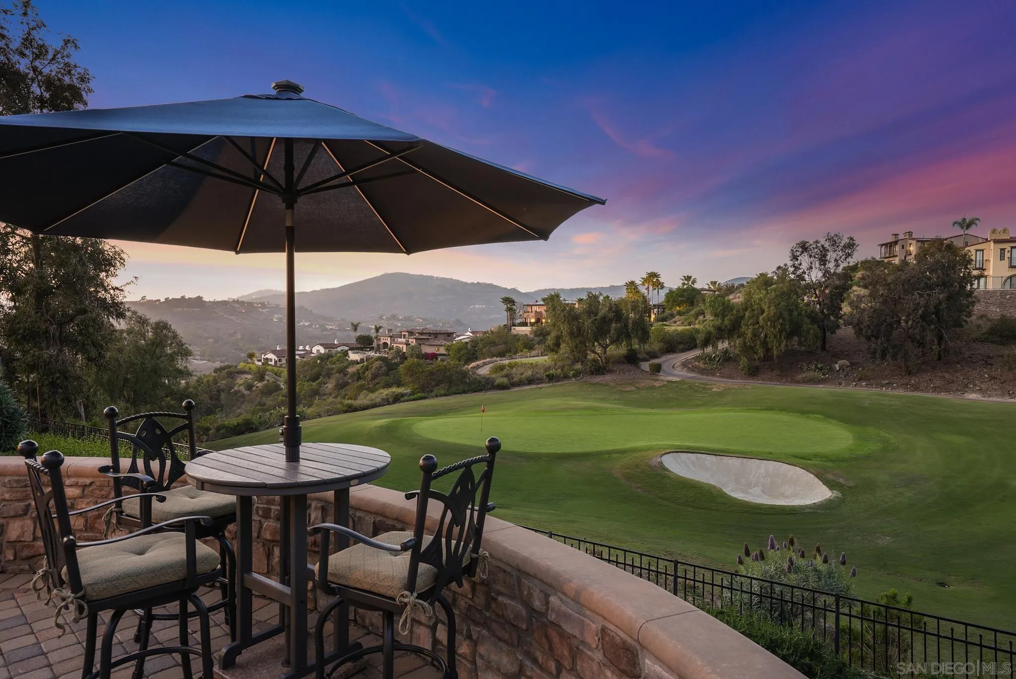 a view of a chair and table in the garden