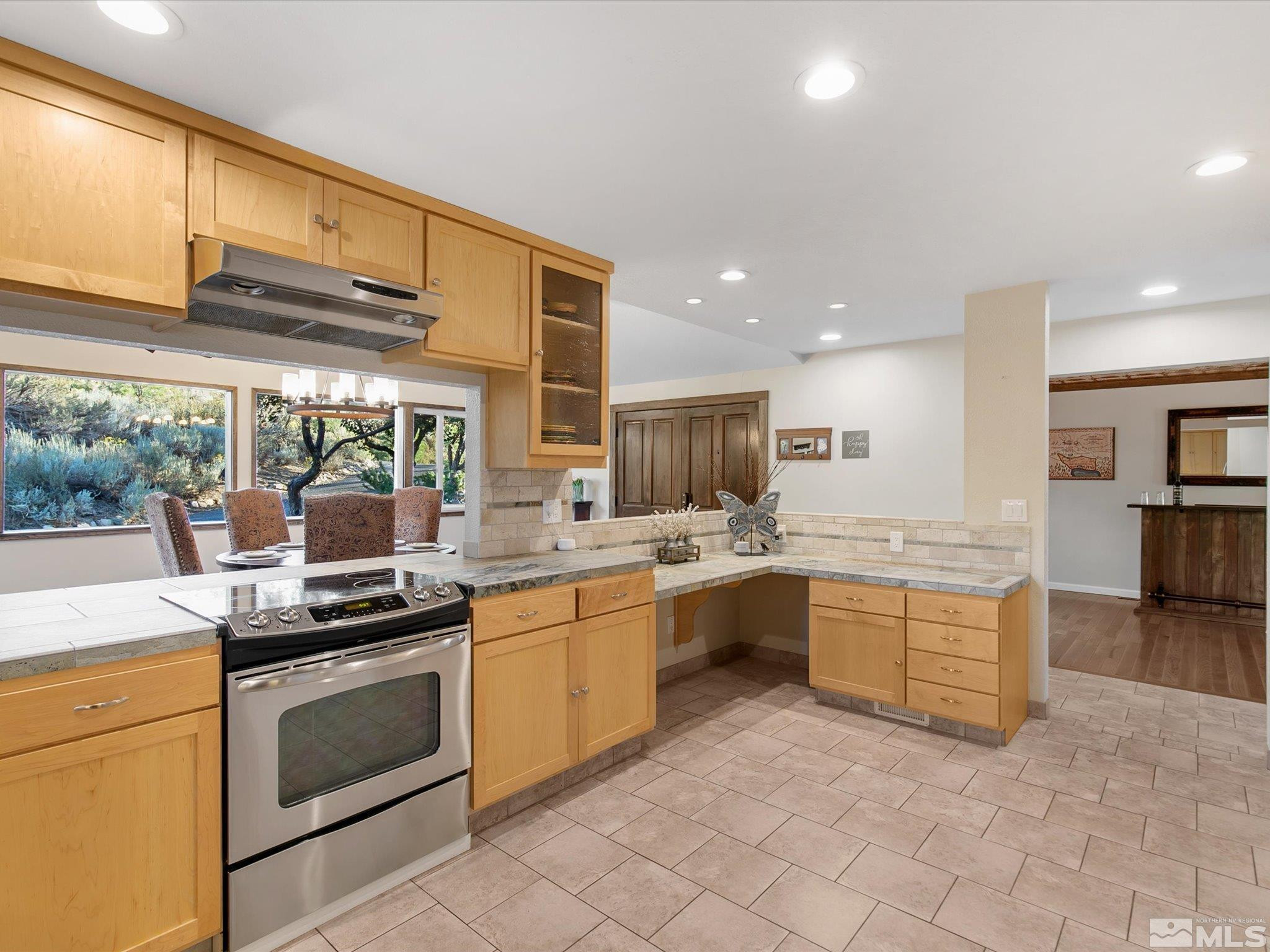 3750 Buckskin Road Carson City, NV 89703 - Photo 12 of 38 a kitchen with stainless steel appliances granite countertop a stove a sink and a refrigerator