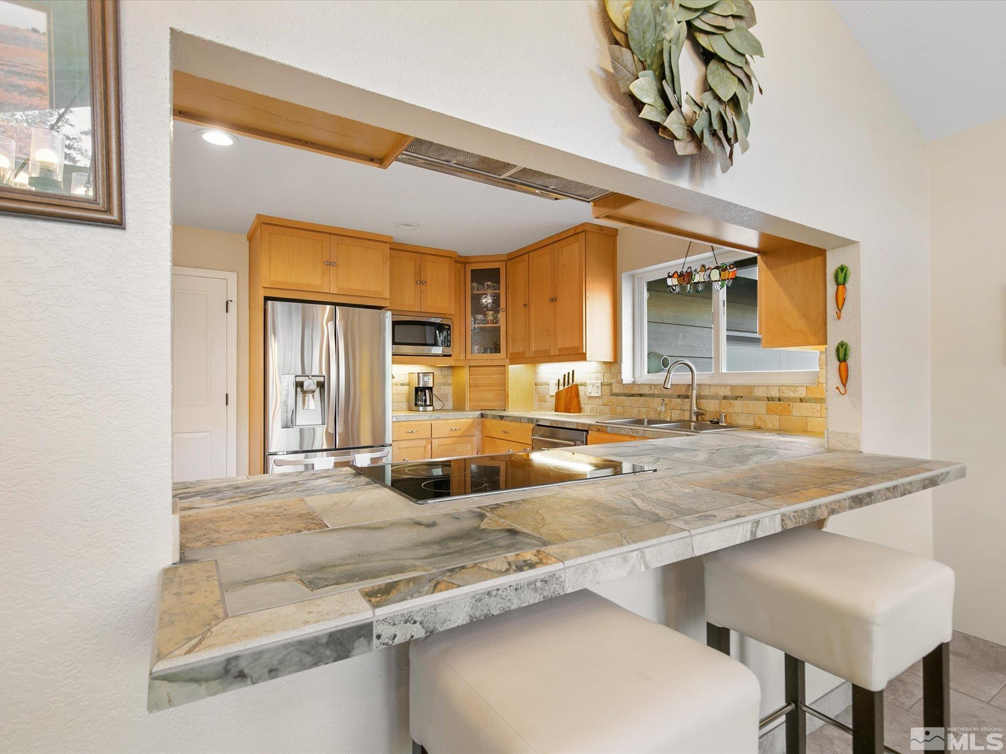 3750 Buckskin Road Carson City, NV 89703 - Photo 13 of 38 a kitchen with stainless steel appliances granite countertop a sink and a refrigerator