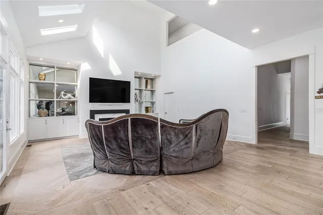 a living room with furniture and a chandelier