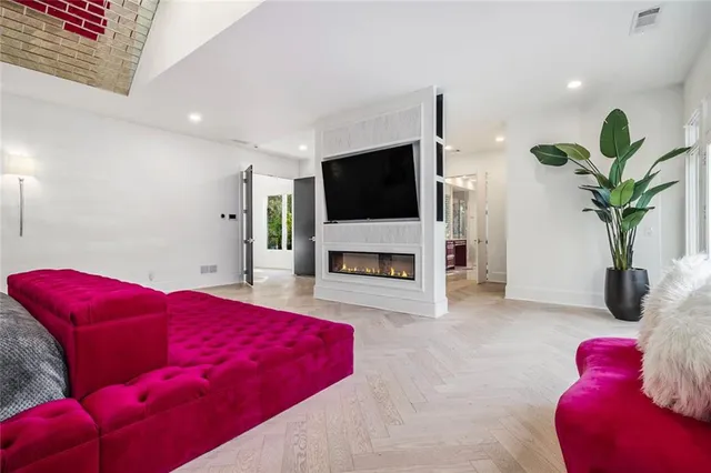 a spacious bathroom with a granite countertop double vanity sink a large mirror and a bathtub